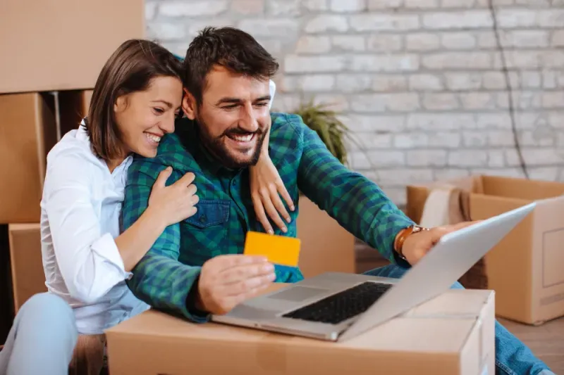 Happy couple looking at their brand new credit card